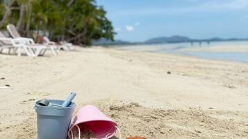 On the beach, sun-loungers, beach umbrellas, beach towels