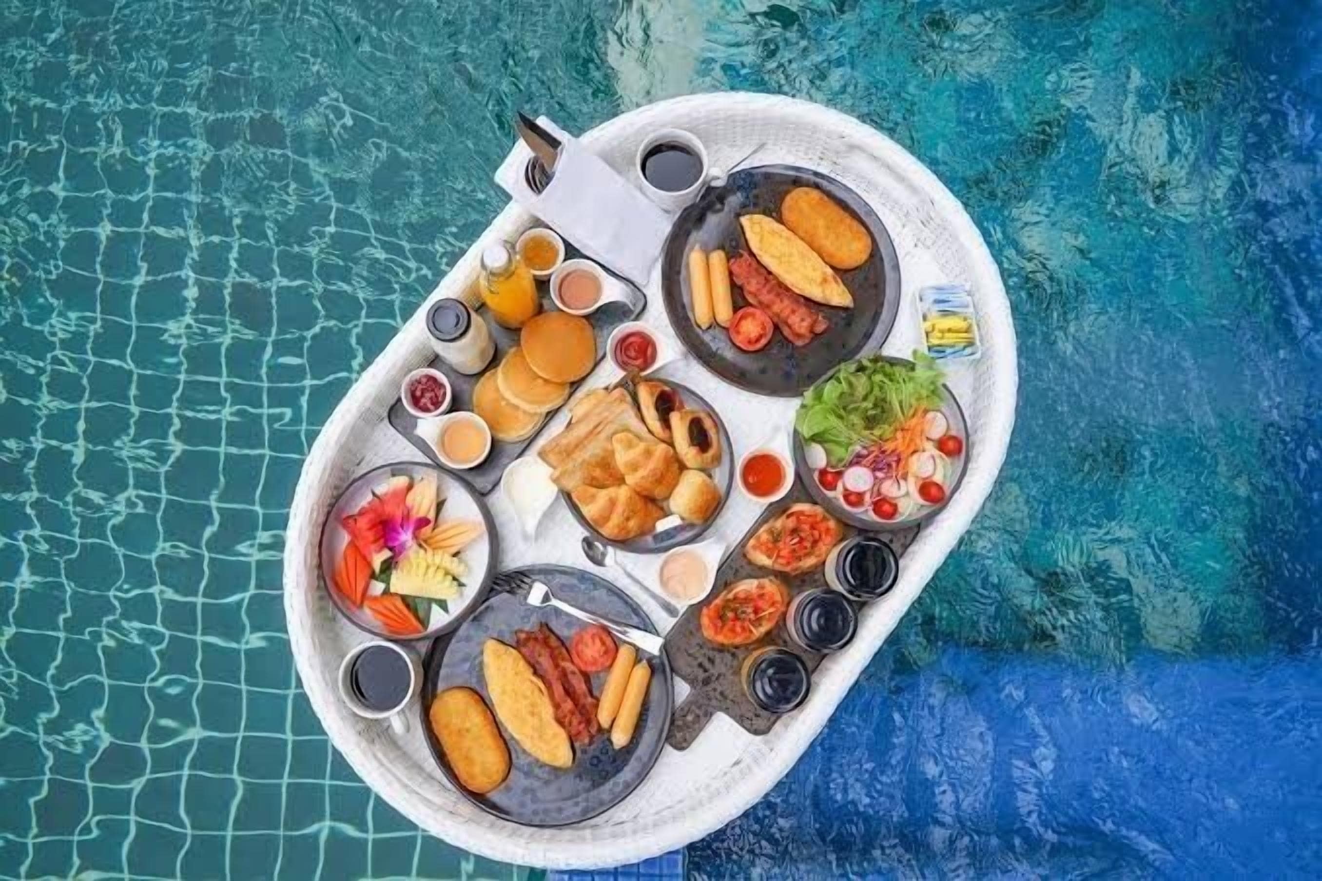 A dining setup with various food items and drinks on a boat.