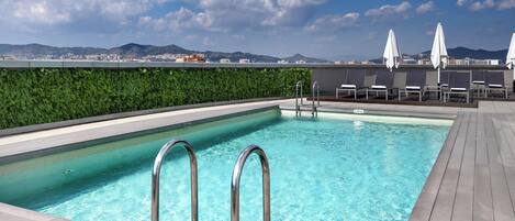 Seasonal outdoor pool, pool umbrellas, pool loungers