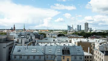 A cityscape with historic and modern buildings, including a prominent church spire and a modern skyscraper.