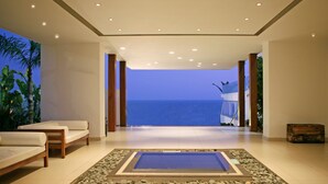 A spacious room with a view of the ocean, a pool, and a seating area with a view. - Napa Mermaid Hotel & Suites (Ayia Napa)