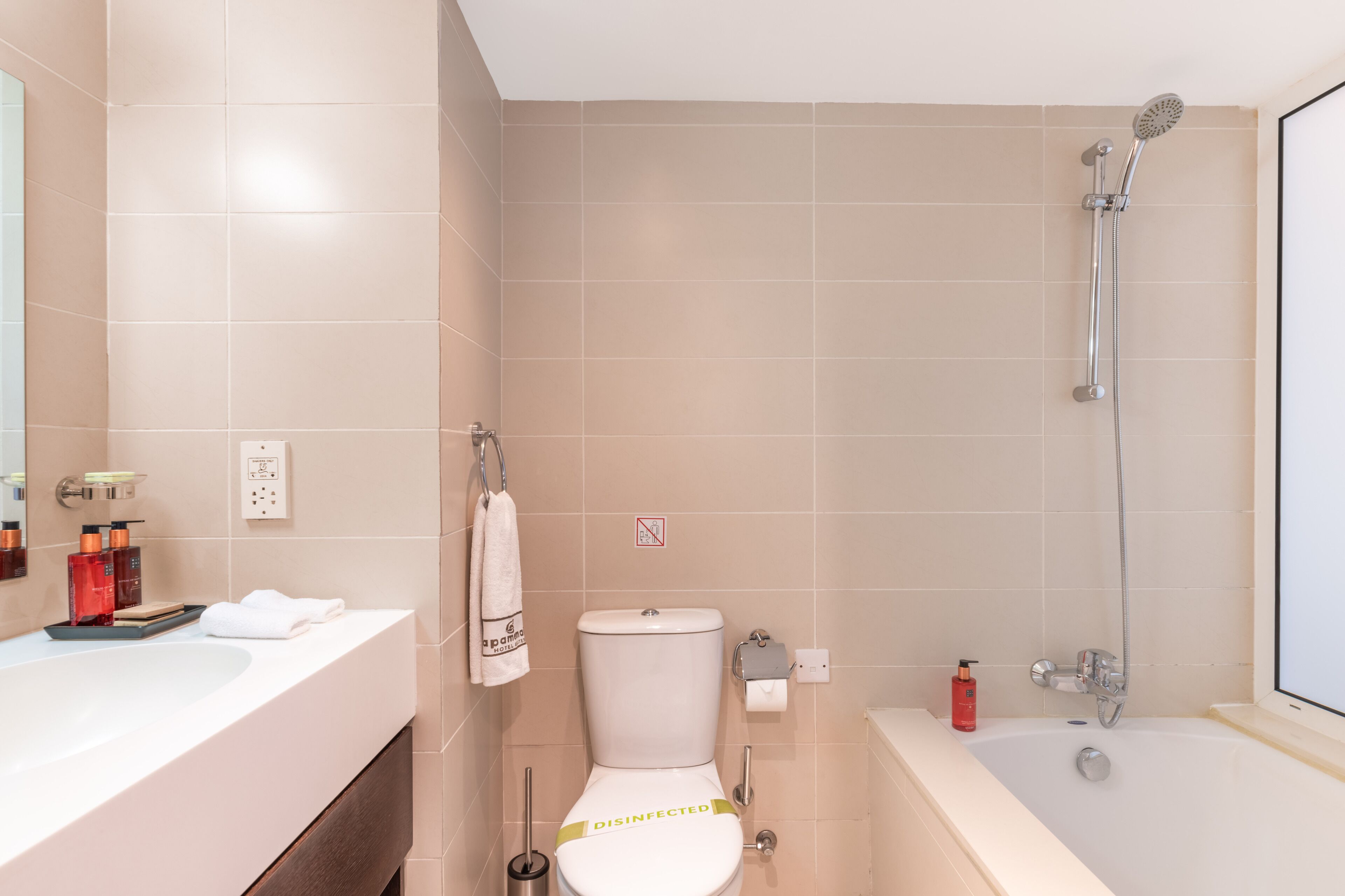 A bathroom with a bathtub, toilet, and sink.