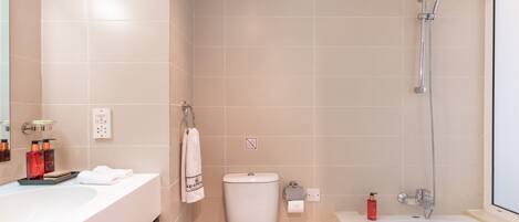 A bathroom with a bathtub, toilet, and sink.