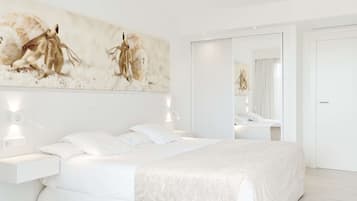 A modern bedroom with a large bed, bedside tables, a mirror, and a wall-mounted artwork.