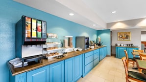 A kitchen area with a coffee machine, a refrigerator, and a counter with food items. - Country Inn & Suites by Radisson, Hot Springs, AR (Hot Springs)