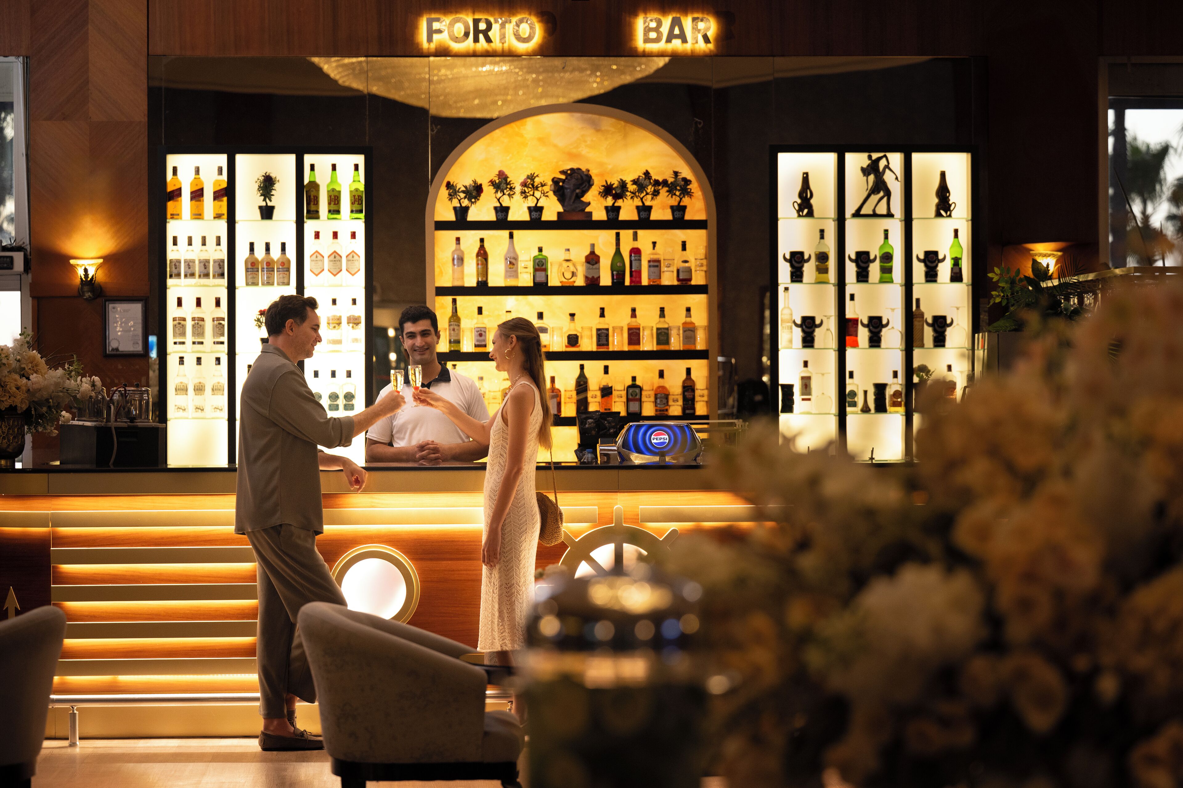 A bar area with shelves of bottles and a sign reading "FORTO BAR".