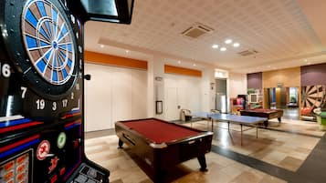 Enjoy games and entertainment in this lively recreational area featuring a dartboard, pool table, table tennis table, and billiards table.