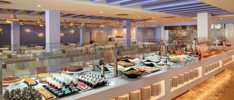 A buffet area with various food options and a modern interior design.