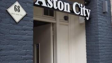 Hotel Aston City sign with a number 68 sign below it.