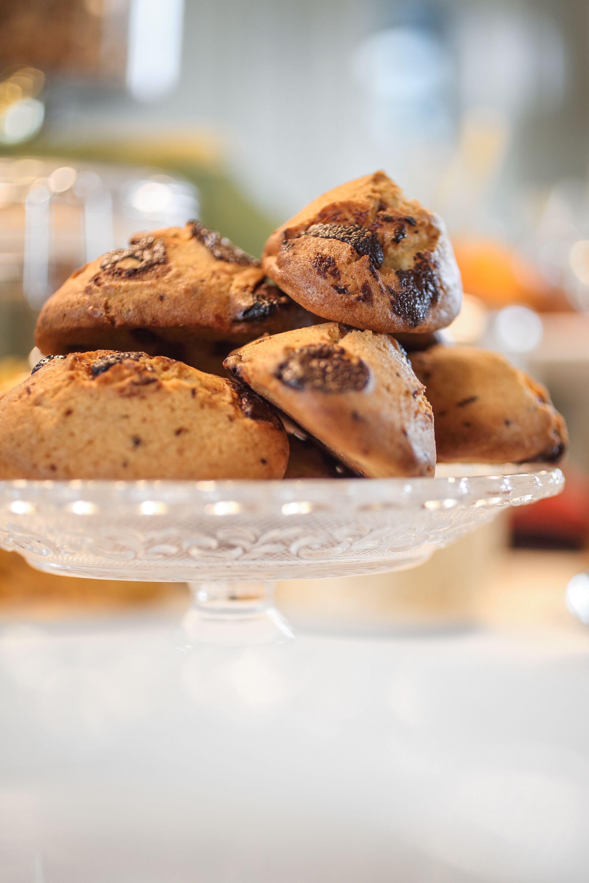 A stack of muffins on a clear glass plate.