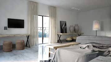 A modern hotel room with a large bed, a desk, a flat-screen TV, and a balcony with curtains.