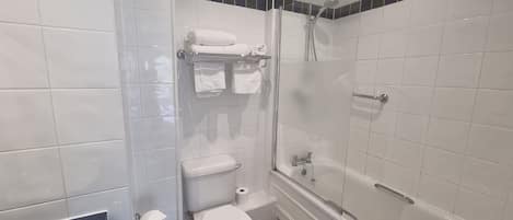 A bathroom with a toilet, a shower, and a bathtub.