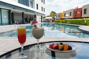 Outdoor pool, open 9:00 AM to 8:00 PM, pool umbrellas, pool loungers