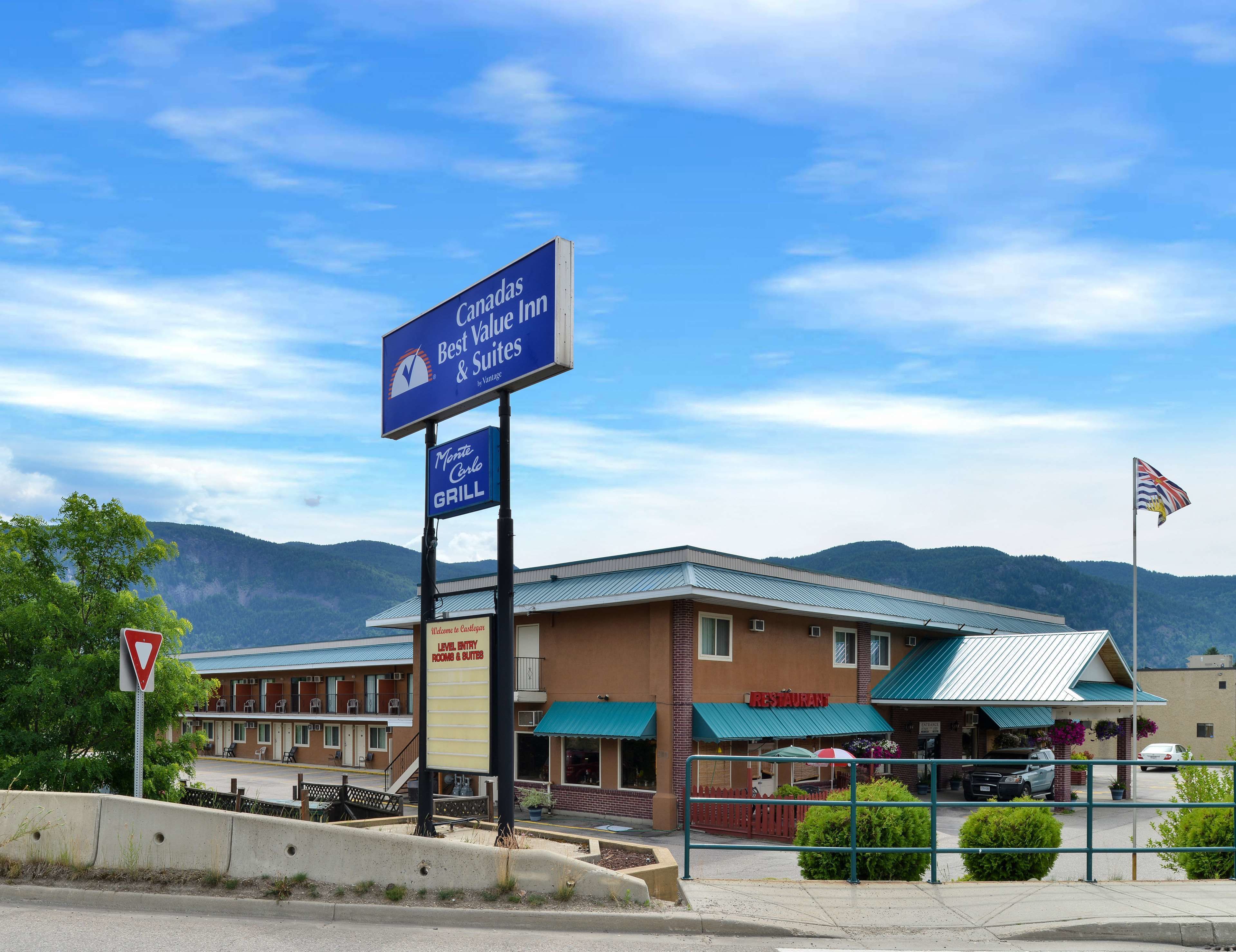 A building with a sign for Canada Best Value Inn and Suites, a restaurant, and a level entry entrance.
