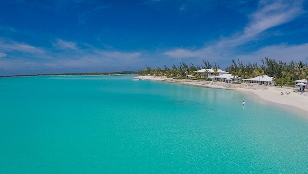 A beach resort with clear turquoise waters, white sandy beach, and overwater bungalows. - Cape Santa Maria Beach Resort (Galliot Cay)