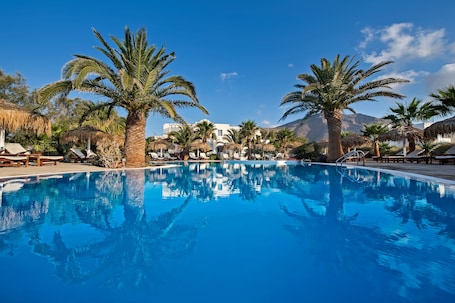 Outdoor pool, pool umbrellas, pool loungers. Atlantis Beach Villa