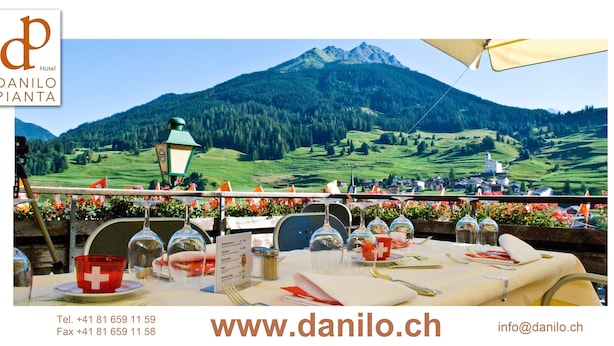 A table set for dining with a mountain view in the background.