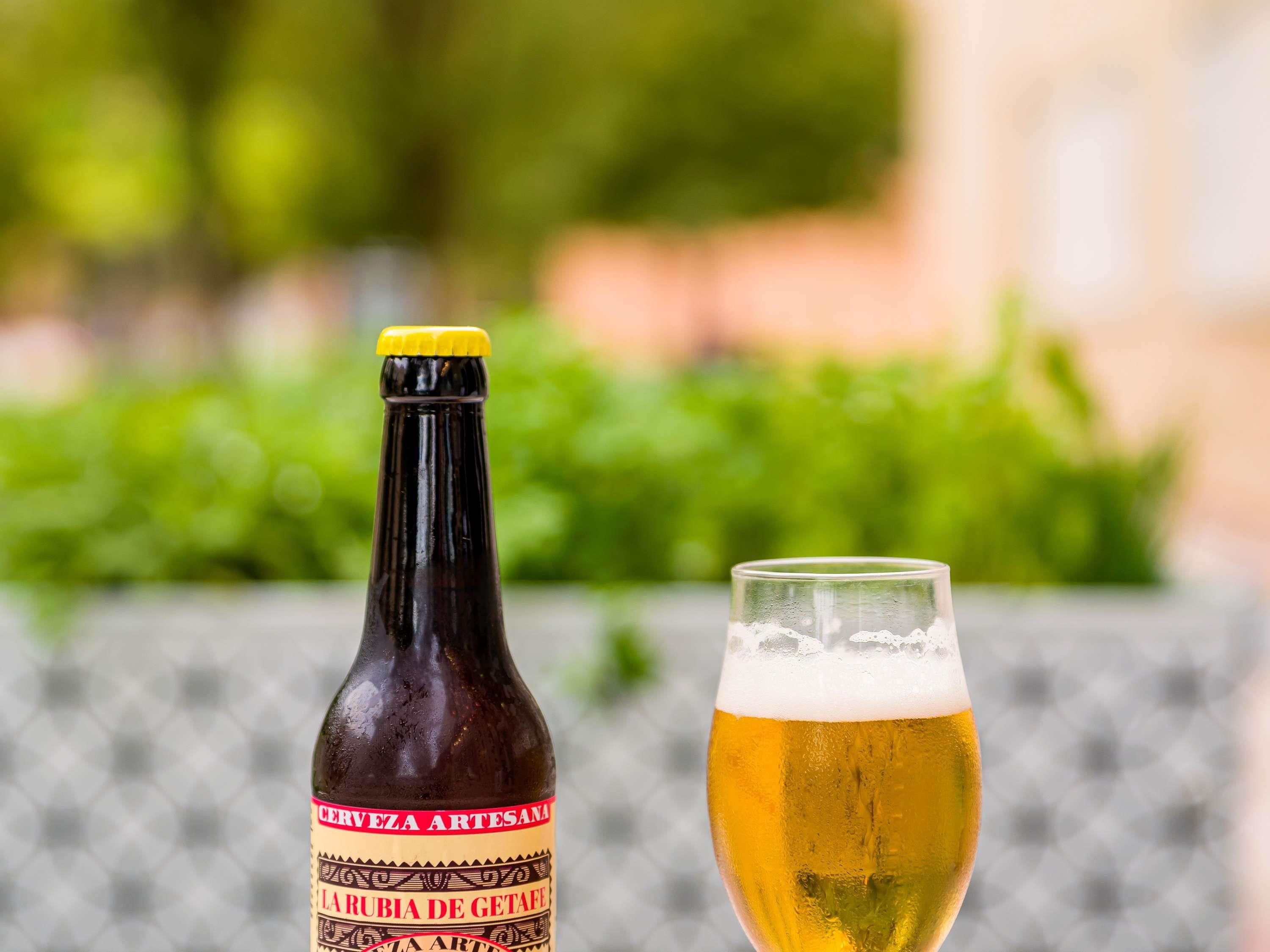 A bottle of beer and a glass of beer.
