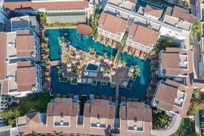 An aerial view of a hotel with multiple swimming pools, outdoor seating areas, and a central courtyard. - Lara Barut Collection-Ultra All Inclusive (Antalya)