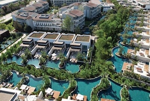 A resort with multiple swimming pools, connected by walkways, and surrounded by lush greenery. - Lara Barut Collection-Ultra All Inclusive (Antalya)