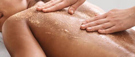 A person receiving a back massage with a focus on the hands and the back.