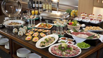 A buffet with various dishes, drinks, and a wine selection.