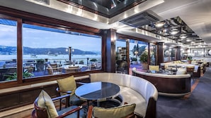 En rummelig bar med udsigt over havnen, med komfortable siddepladser og moderne design.