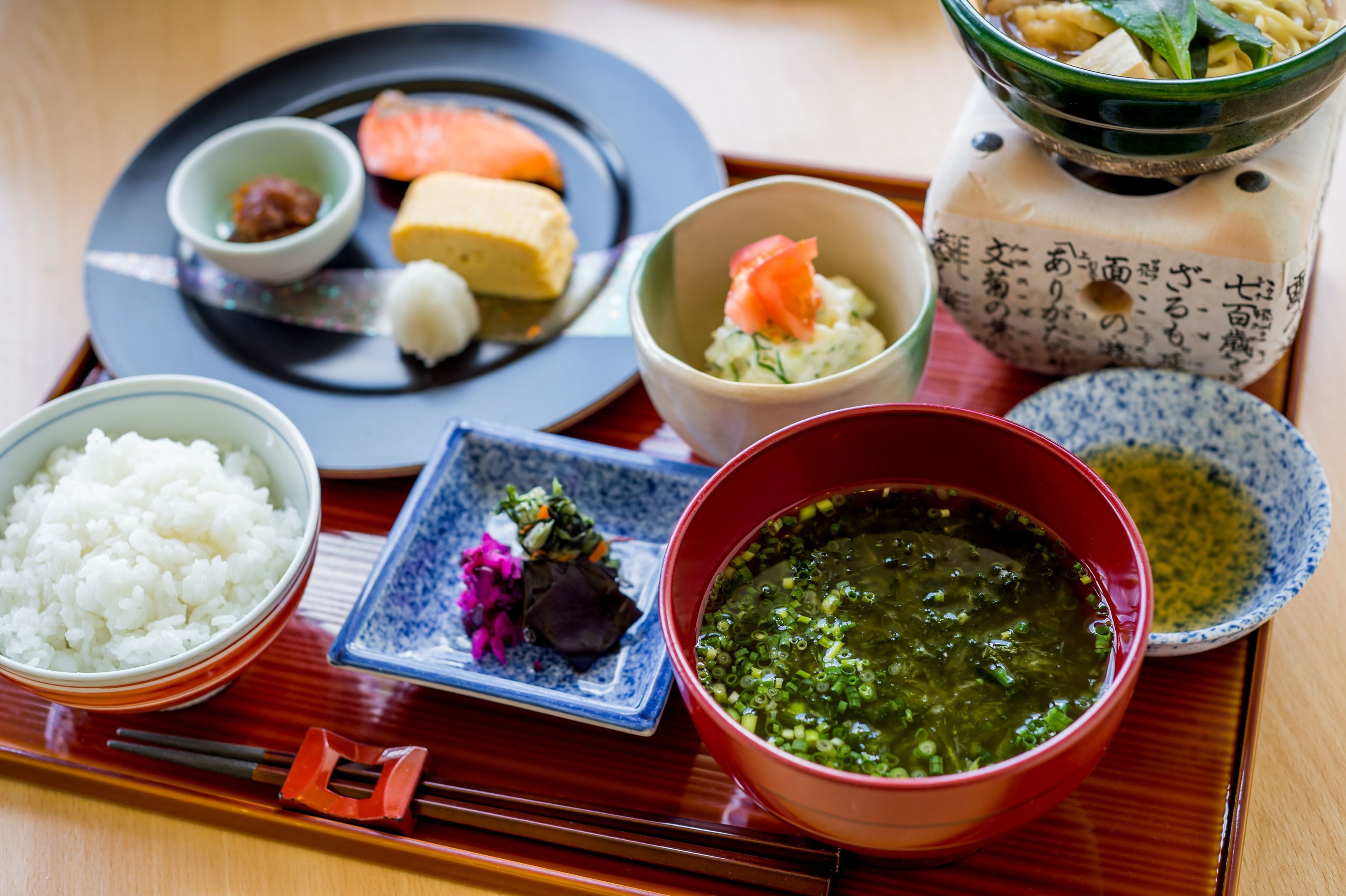 A traditional Japanese meal with various dishes on a tray.