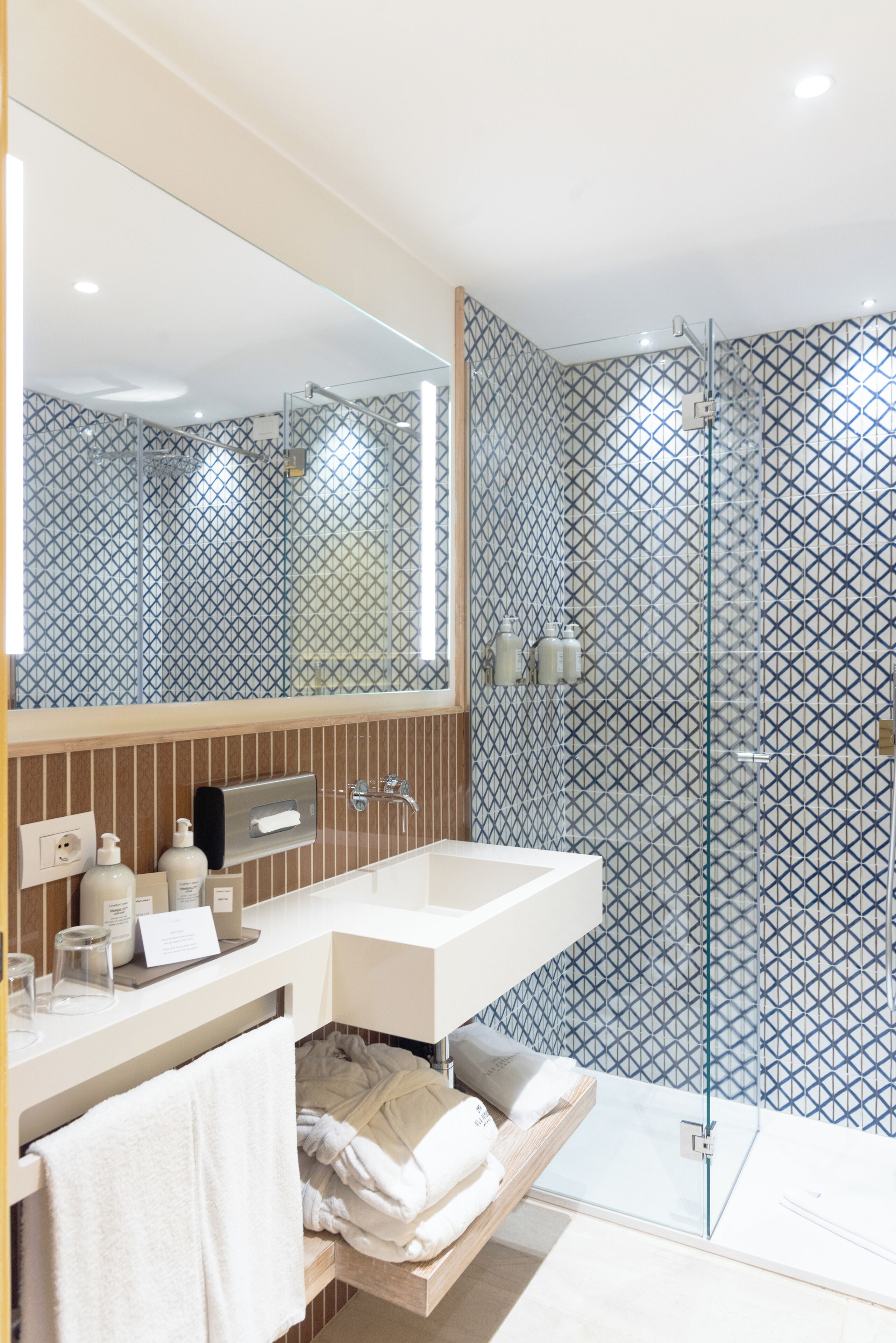 designer toiletries, hair dryer, bathrobes, slippers