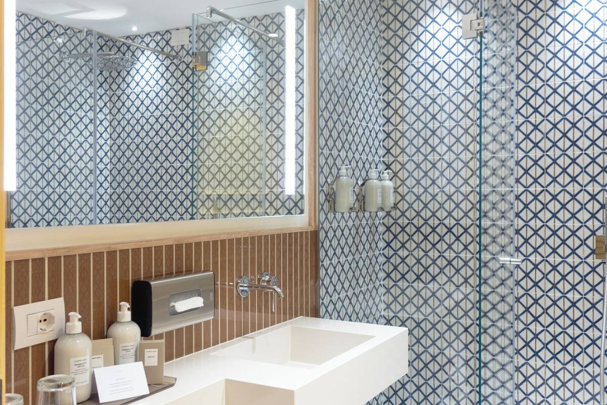 designer toiletries, hair dryer, bathrobes, slippers