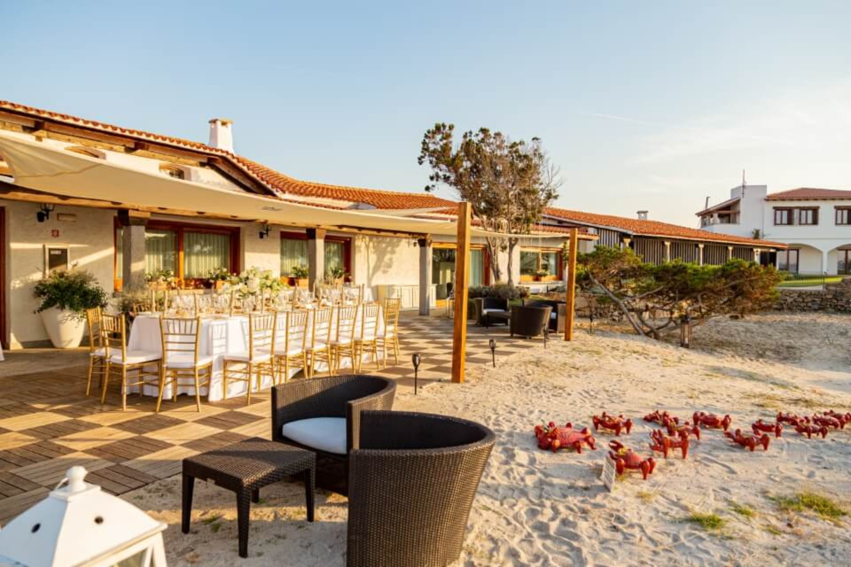 A beachside patio with outdoor seating and a dining area.