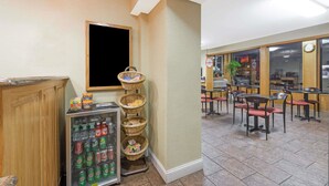 A restaurant with a self-service beverage station, wicker baskets, and a seating area with chairs and tables.
