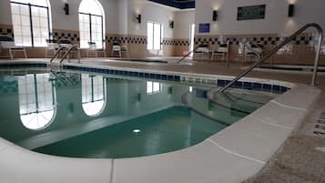 Relax by the pool surrounded by a checkered deck and arched windows.
