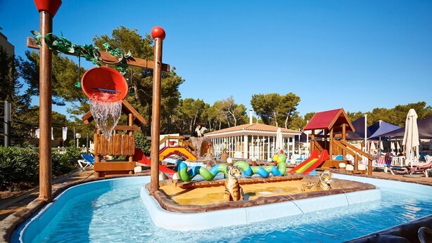 A pool area with slides, a water play structure, and lounge chairs. - Invisa Hotel Ereso All Inclusive (Santa Eulalia del Rio)