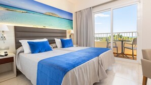 A hotel room with a large bed, a nightstand, a desk, a balcony with a table and chairs, and a painting of a beach scene. - Invisa Hotel Ereso All Inclusive (Santa Eulalia del Rio)