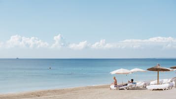 On the beach, sun loungers, beach umbrellas, beach bar
