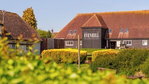 A traditional building with a sign reading "The Evenhill Accommodation." - The Evenhill (Canterbury)