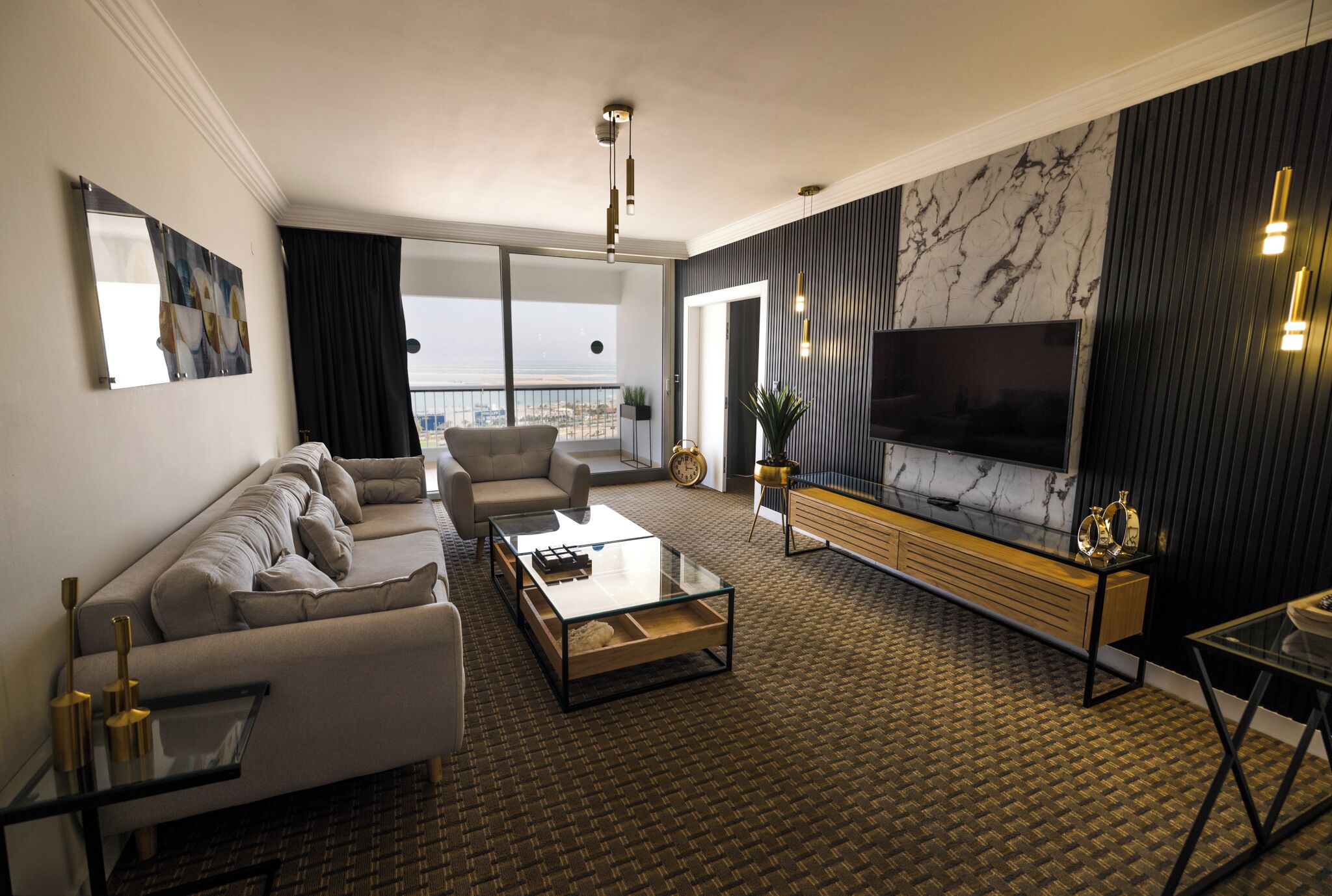 A modern living room with a sofa, coffee table, and TV.