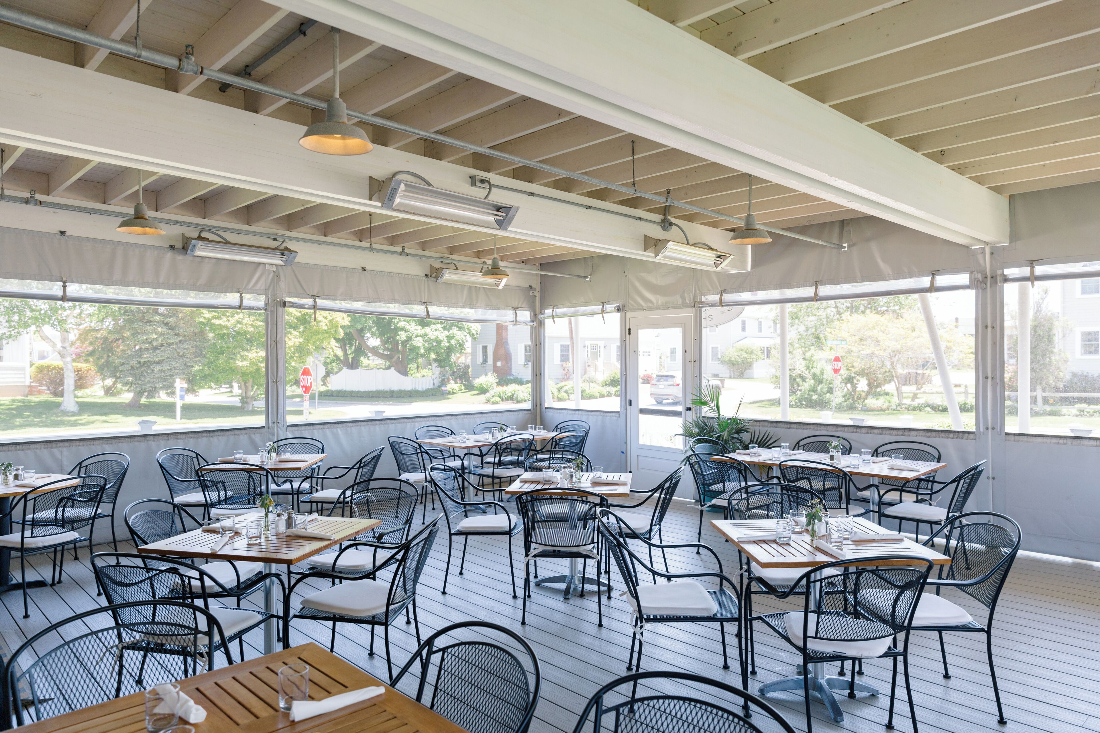 An indoor dining area with tables and chairs arranged for guests.
