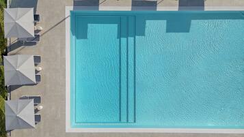 Seasonal outdoor pool, open 9:00 AM to 7:00 PM, pool umbrellas