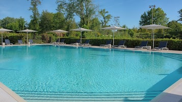 Seasonal outdoor pool, open 9:00 AM to 7:00 PM, pool umbrellas