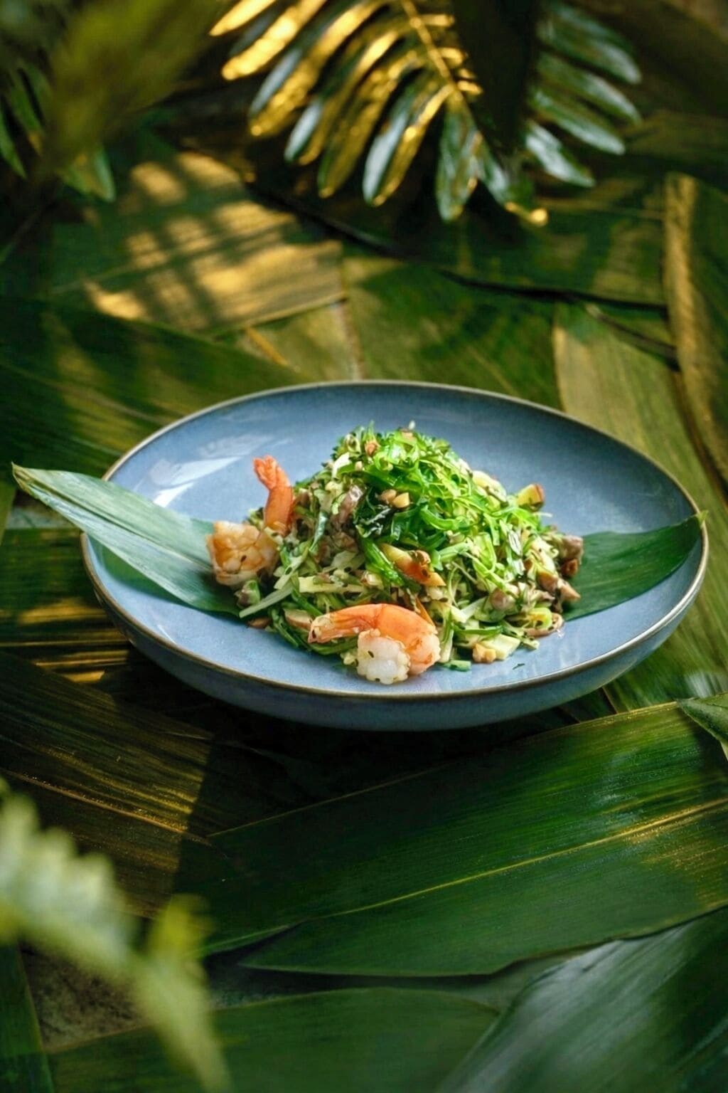 A plate of food on a table with a leaf underneath.