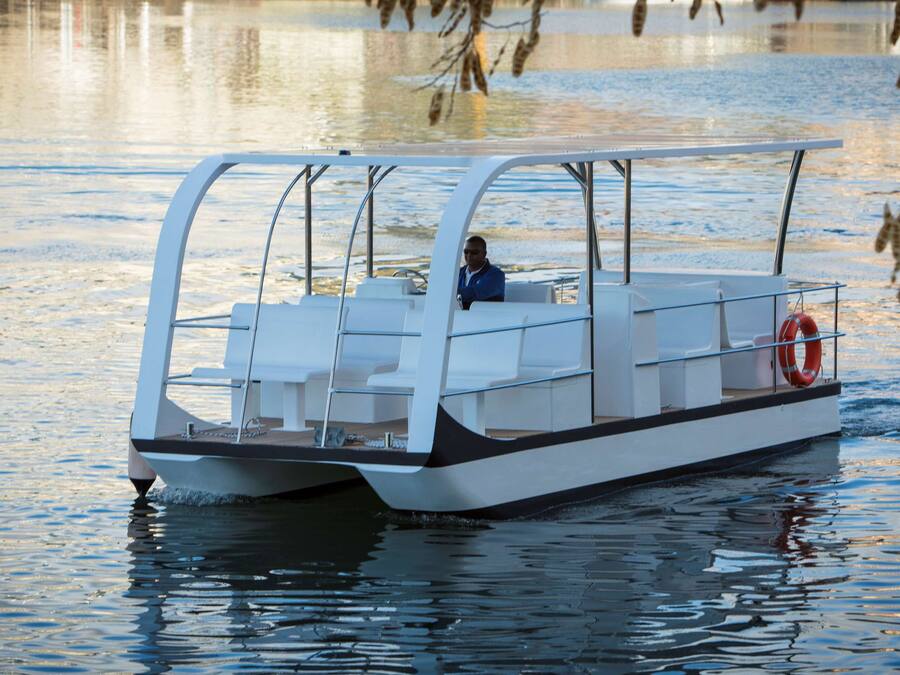A small, modern boat with a covered seating area and a lifebuoy.