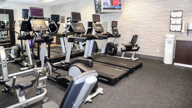 A gym with treadmills, ellipticals, and weight machines. - Courtyard by Marriott Toronto Brampton (Brampton)