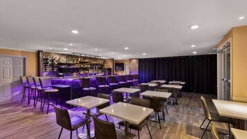 A bar area with a bar counter, seating, and a stage.