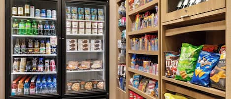A vending machine area with various snacks and beverages.