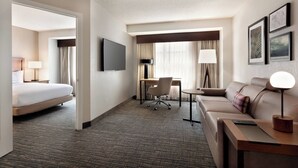 A hotel room with a bed, a desk, a sofa, and a TV. - Residence Inn by Marriott Baltimore Inner Harbor (Baltimore)