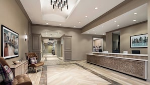 A hotel lobby with a reception desk, seating area, and a hallway leading to other rooms. - Residence Inn by Marriott Baltimore Inner Harbor (Baltimore)