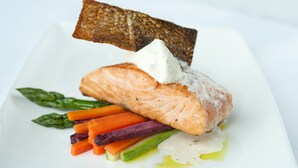 A plate with salmon, asparagus, carrots, and a piece of bread. - Crowne Plaza Shanghai Pudong by IHG (Shanghai)