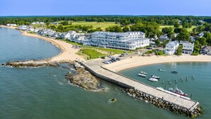 A coastal hotel with a pier, beach, and boats. - Madison Beach Hotel (Madison)